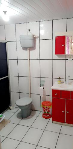 a bathroom with a toilet and a sink at Pousada Costa dos Canions in Cambará