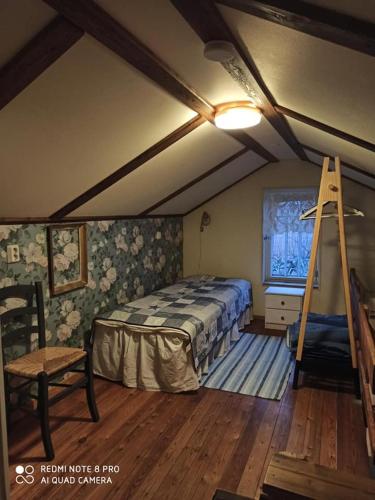 a bedroom with a bed and a ladder in it at Kirkkokadun Amanda ja Olga in Uusikaupunki