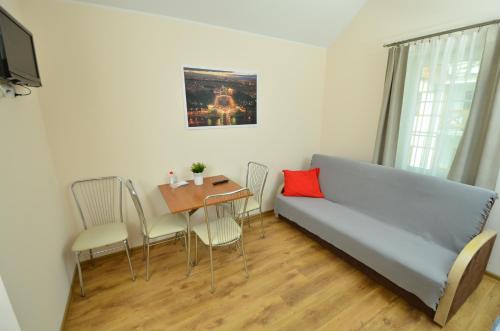 a living room with a couch and a table at Apartamenty Zefir in Rowy