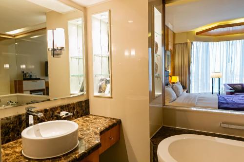 a bathroom with a sink and a large mirror at Lagos Continental Hotel in Lagos