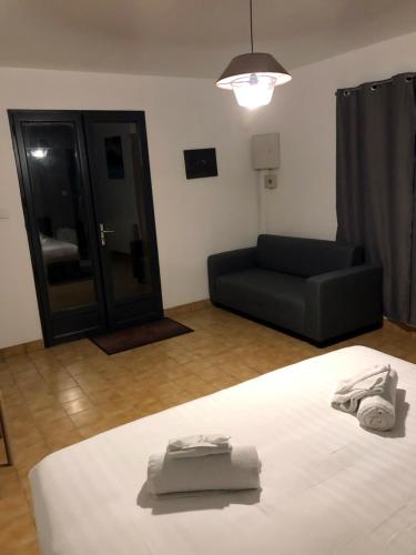 a living room with a bed and a couch at Appartement LOGIS DES MARAIS in Saint-Philbert-de-Grand-Lieu
