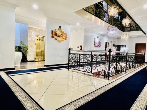 a lobby with a black railing and a staircase at Base Ethiopia International Hotel in Addis Ababa
