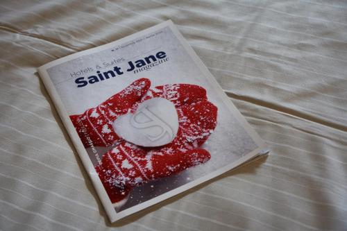 a book of santini jam on a bed at Hotel Piandineve in Passo del Tonale