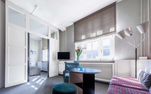 a living room with a couch and a table at Apartment040 in Hamburg