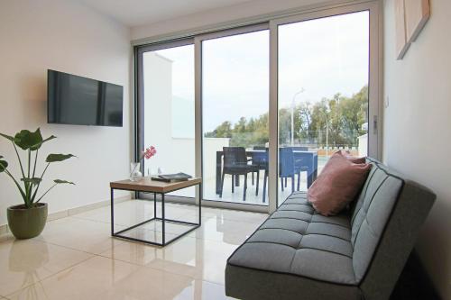 uma sala de estar com um sofá e uma mesa em Phaedrus Living - Seaside Luxury Flat Harbour 105 em Paphos