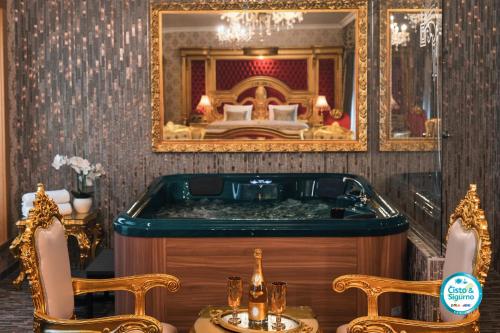 a bathroom with a tub and a bedroom with a bed at Prezident Palace Belgrade - Adults Only in Belgrade