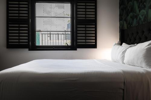 a bedroom with a white bed and a window at The Sobro Guest House by AvantStay in Nashville