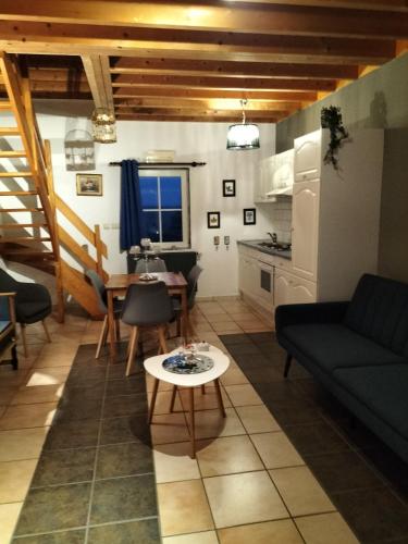 a living room with a couch and a table at Gîte du Cheval Blanc à Houmont in Sainte-Ode