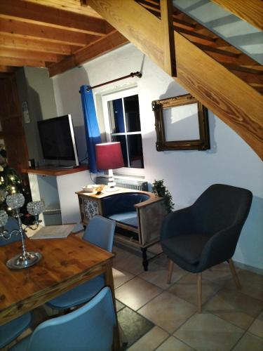 a room with a desk and a chair and a table at Gîte du Cheval Blanc à Houmont in Sainte-Ode