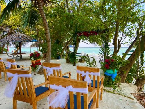 a wedding ceremony on the beach with chairs and flowers at RISING SUN BEACH VIEW in Thinadhoo
