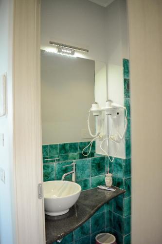 a bathroom with a sink and a mirror at Nnakkara Guest House in Santo Stefano di Camastra