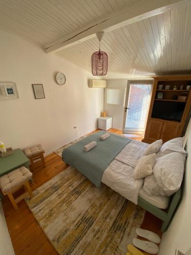 a bedroom with a bed and a table and a window at Enni Guest House in Mostar