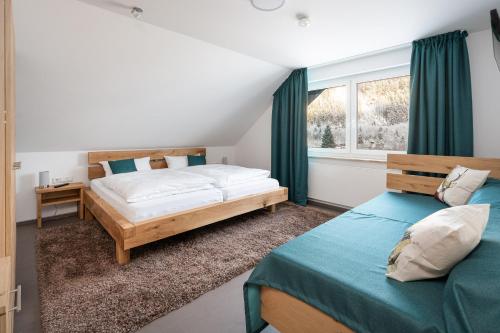 a bedroom with two beds and a window at Landhaus Frese in Willingen