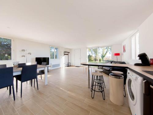 a kitchen and living room with a washer and dryer at La Tour de la Conterie in Beaumont-Village