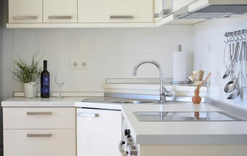 a kitchen with white cabinets and a sink at Villa Klaudia in Trogir