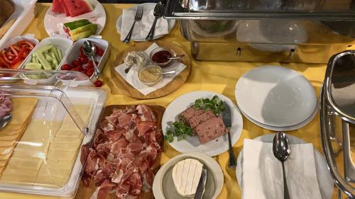 a table with a bunch of food on it at JOHAN HOTEL in Zlín
