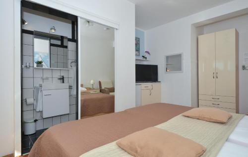 a bedroom with a large bed and a bathroom at Villa Klaudia in Trogir