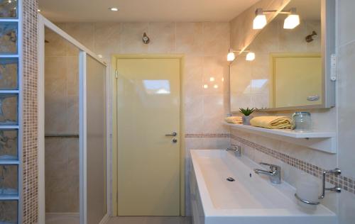 a bathroom with a shower and a sink and a mirror at Villa Klaudia in Trogir