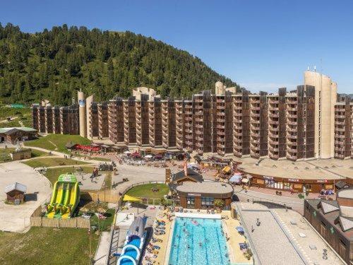 a large hotel with a pool and a resort at Studio transformé en 2 pièces avec cloison amovible sur La Plagne Bellecôte in Sangot