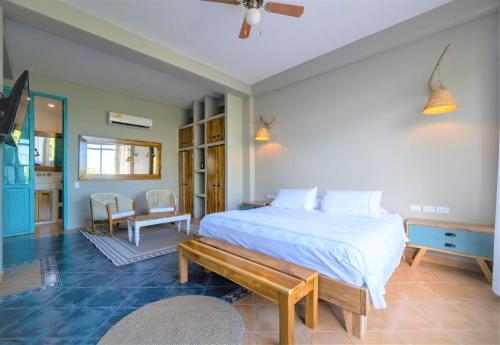 a bedroom with a large bed and a large window at Hotel Fenix Beach Cartagena in Tierra Bomba