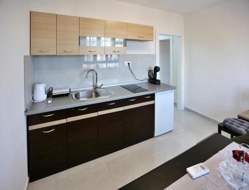 a kitchen with a sink and a counter top at New studio apartman Emda u centru Splita in Split