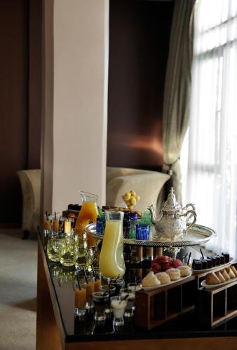 a buffet with drinks and other items on a table at Le Médina Essaouira Thalassa Sea & Spa - MGallery Collection in Essaouira