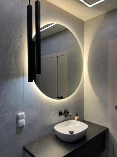 a bathroom with a sink and a mirror at Apartament Sweet Dream Longinówka in Brodnica