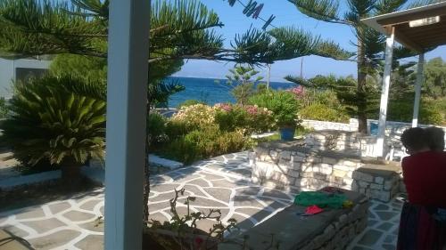a woman looking out of a window at the ocean at Ragoussis House in Logaras