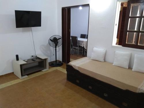 a bedroom with a bed and a flat screen tv at Casa Tranquila en pasaje , Villa Carlos Paz in Villa Carlos Paz