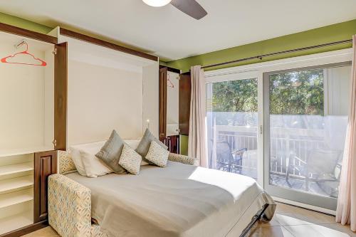 a bedroom with a bed and a large window at Breakers At Hilton Head in Hilton Head Island