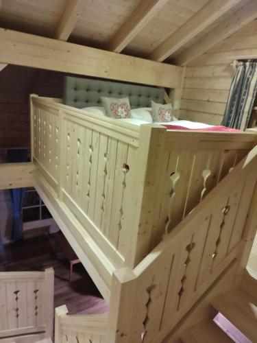 a childs bunk bed in a wooden house at Schlosswirt Chalets & Apartments in Großkirchheim
