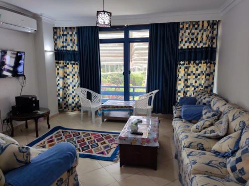 a living room with a couch and a table at 2bed rooms 95m, Garden&sea view, first floor, Family only دور اول بمدخل مستقل in Alexandria