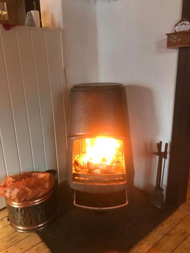 a fireplace with a fire inside of it at Rauland Hytteutleige in Rauland
