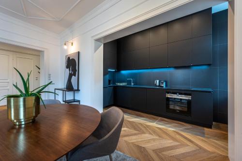 a dining room with a table and a large tv at Wishlist Prague Residences Malá Strana in Prague