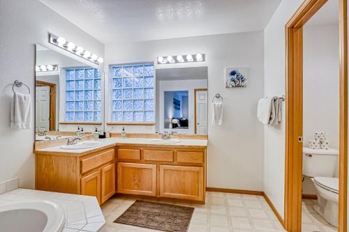 a bathroom with a sink and a toilet and a mirror at Golden Pheasant Retreat in Redmond