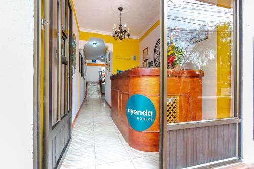 a hallway of a store with a sign on a window at Hotel Puerta del Sol Popayan in Popayan