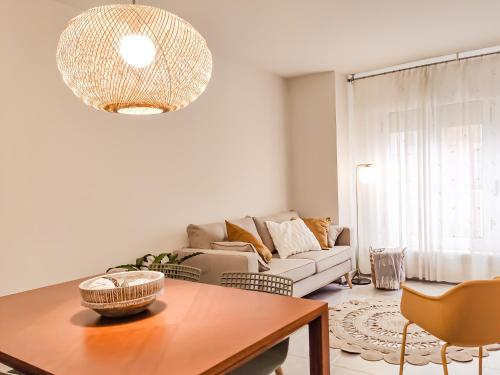 a living room with a couch and a table at Apartament Natura amb Calma in Olot