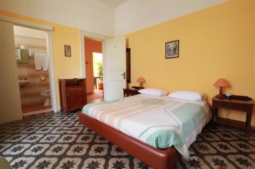 a bedroom with a large bed and a bathroom at Hotel Anastasia in Rhodes Town