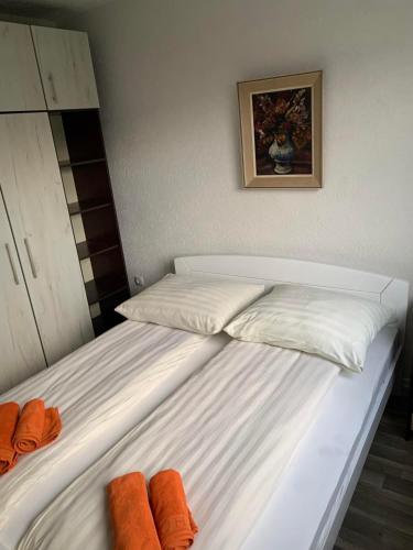 a bedroom with two beds with orange towels on them at Apartmani Balibeg in Sarajevo