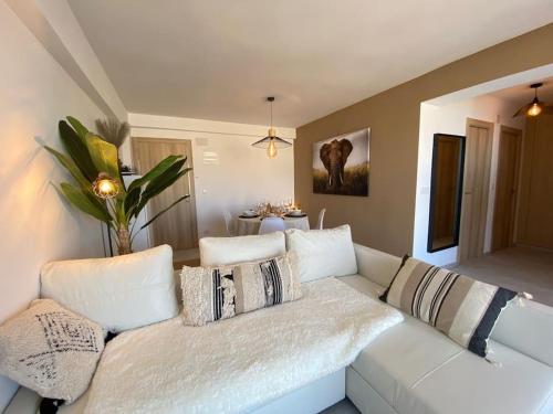 a living room with a white couch with pillows at Cosy flat with magnificent views in L'Albir in Albir