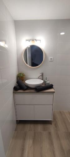 a bathroom with a sink and a mirror at villa cocolo in Villanúa