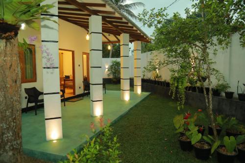 a courtyard of a house with lights on it at Villa Green Heaven Hikkaduwa in Hikkaduwa