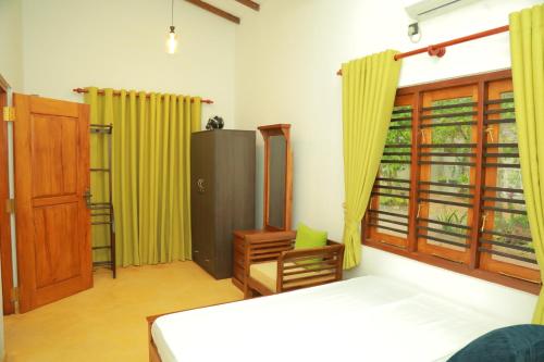 En eller flere senge i et værelse på Villa Green Heaven Hikkaduwa
