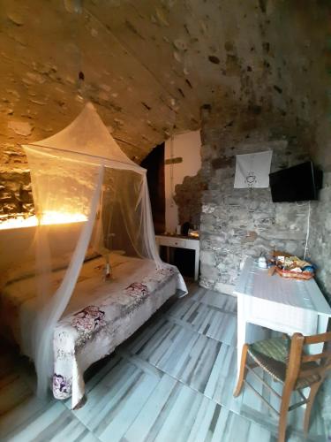 ein Schlafzimmer mit einem Bett und einem Tisch in einem Zimmer in der Unterkunft La grotta dell'Antica Calvasino - Jacuzzi in Lezzeno