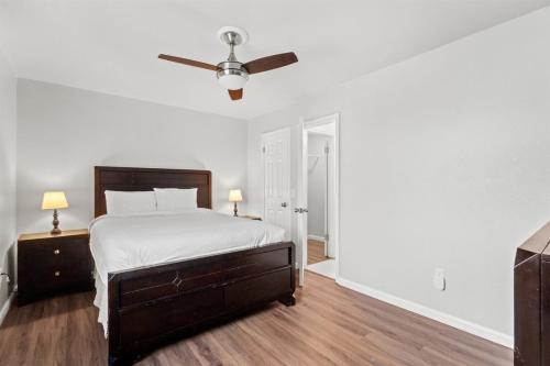 a white bedroom with a bed and a ceiling fan at 5218 Beach Dr A in Panama City Beach