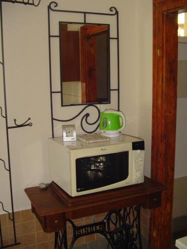 a microwave on a table with a green cup on top at Everlast in Štúrovo