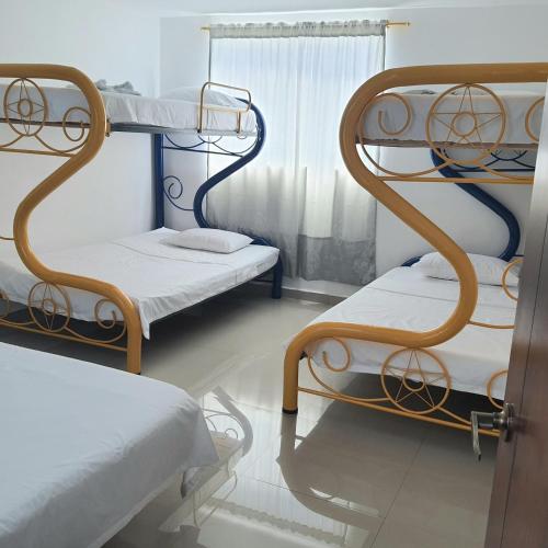 a room with two bunk beds and a window at Hotel Velices in Buga