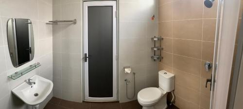 a bathroom with a toilet and a sink at BEDONG GOLF VILLA in Bedung