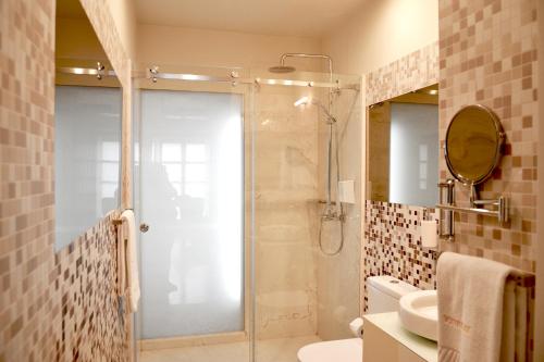 a bathroom with a shower and a toilet and a sink at Stay in the heart of Porto! in Porto