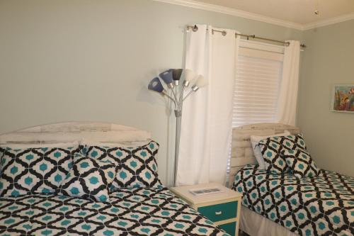 a bedroom with two beds and a lamp at A Place At The Beach V in Atlantic Beach
